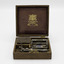 Open box with all elements of the razor in their compartments and showing the manufacturer’s label on the inside lid