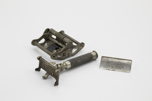 Three parts of the razor, double sided blade holder, razor handle and safety cover for blade