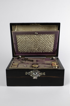 Sewing box front on displaying it’s shell inlaid keyhole and the ruched lid insert