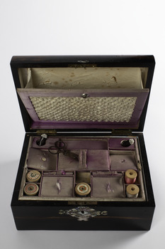 sewing box showing the fabric covered lids on the dividers and ruched insert sitting forward possibly somewhere to put patterns for embroidery 