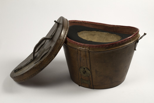 Leather hat box opened with top hat  upside down inside