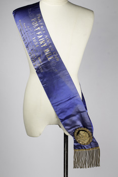 A winner’s sash with gold metal badge
