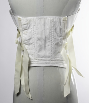 back of garment showing ribbons used to tighten it.