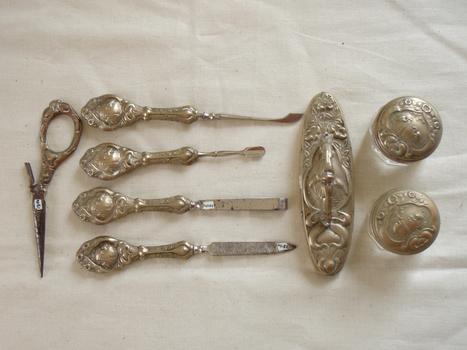 Manicure utensils and pots with silver handles and tops
