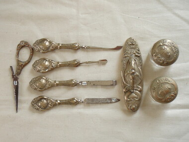 Manicure utensils and pots with silver handles and tops