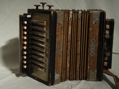 Closed piano accordion with metal plates and fake leather folds