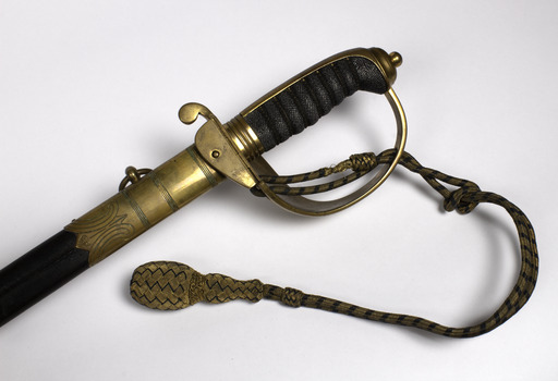 Detail of handle,decorative engraving on upper end of scabbard, and rope and tassel at the top of the sword