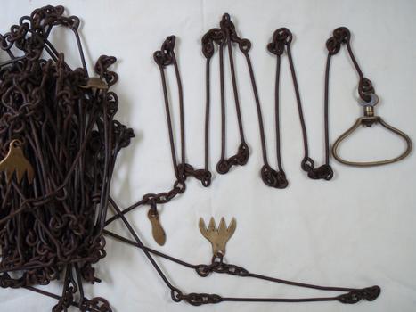 Large chain with brass markers to denote a length measurement and handles at each end 