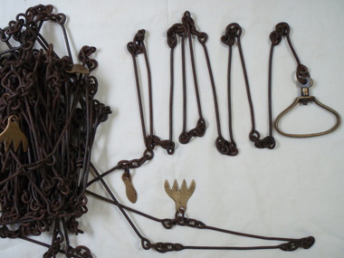 Large chain with brass markers to denote a length measurement and handles at each end 