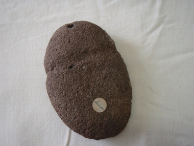 Aboriginal axe head with indent where attached to a handle