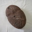 Showing a hole which has been cut through top of hammer or axe