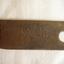 Handmade metal button cleaning helper showing initials hand hammered into metal
