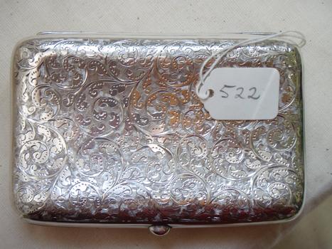 Underside of silver cigar case continuation of detailed decoration