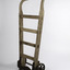 Ship’s cargo trolley with 4 braces and one handle longer than the other with heavy metal wheels and step 
