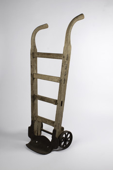 Ship’s cargo trolley with 4 braces and one handle longer than the other with heavy metal wheels and step 