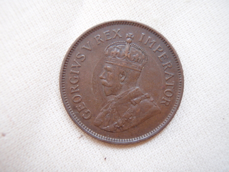 King George V portrait with text around rim