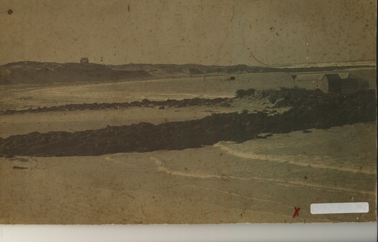 Boarding school Bay showing the stone reef and the bathing boxes. The house on the hill on the left is still a mystery 