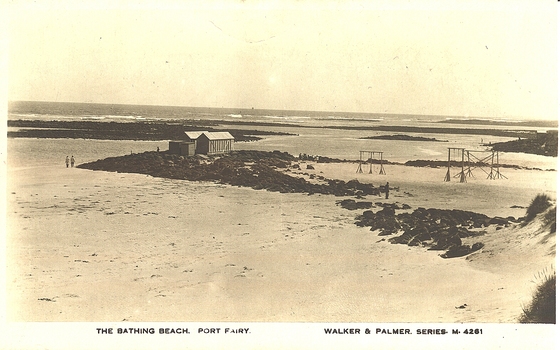 Bathing boxes on rocks. Playground on right