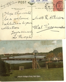 View across Moyne river looking West with water windmill in foreground and traffic bridge inn middle ground