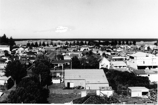 Overview, Bank St. Large building next to service station  in foreground. Theatre across the road on the right