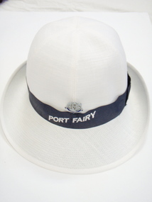 White ladies hat with navy band with Port Fairy printed and sliver badge