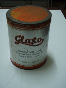 Round tin with orange lid and band around base made to hold milk powder for infants