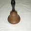 Plain brass hand bell with black painted wooden handle