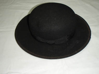 Black bowl shaped hat  used for riding