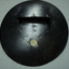 Metal circle with round attachment hole and long slit with a cover and wire barrier