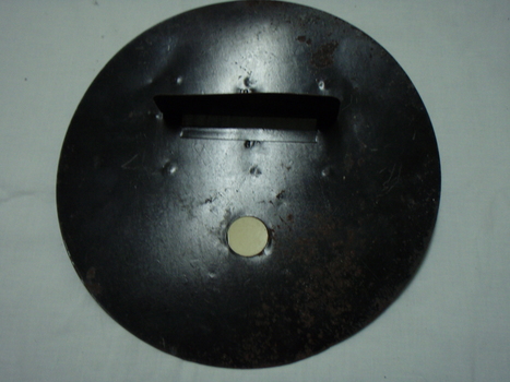 Metal circle with round attachment hole and long slit with a cover and wire barrier