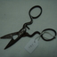 Scissors with wide blades and a brake between the two parts