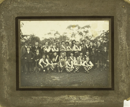Formal pose of group of Football players, officials and children