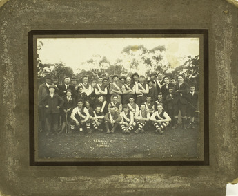 Formal pose of group of Football players, officials and children