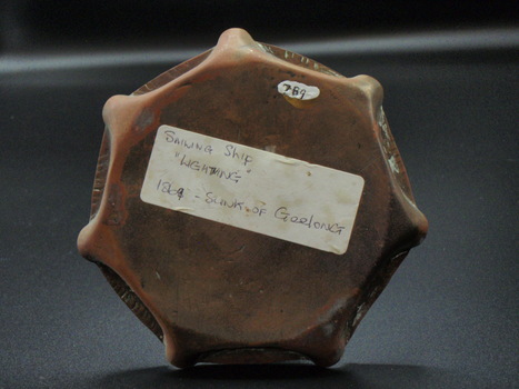 Base of ashtray with label with identifier at top and information below
