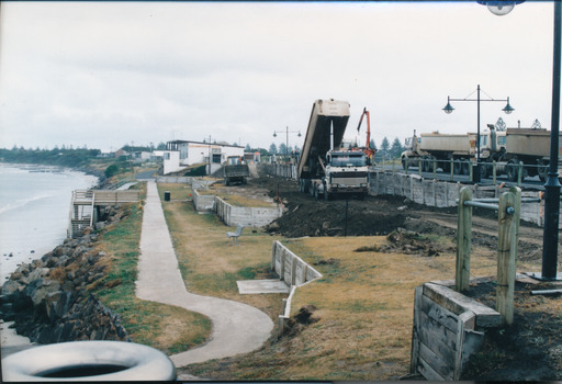 Pathway along edge with a tip truck in background