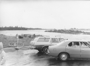 Cars parked at causeway during storm