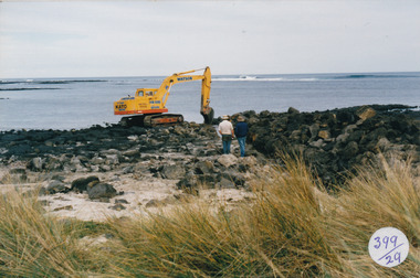 Digger removing rocks from South Beach