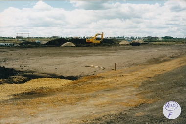 Drainage works with pipes at the left and large machine 
