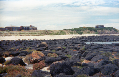 Rocks at South Beach. Ocean Drive houses in the background