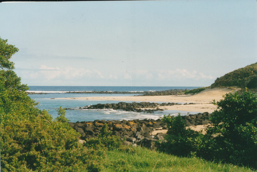 Coloured photograph of beach and bay