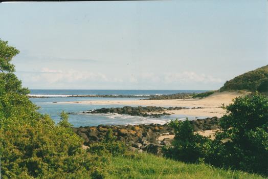 Coloured photograph of beach and bay