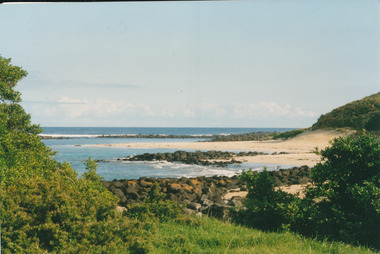 Coloured photograph of beach and bay