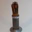 Metal cylinder with round base containing various wire cables wrapped in paper in tight bundle. 