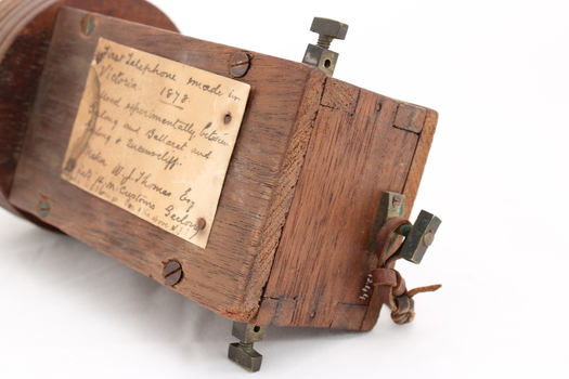 Wooden rectangular device with cone shaped speaker/microphone at one end.