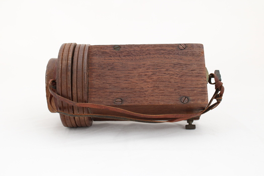 Wooden rectangular device with cone shaped speaker/microphone at one end.