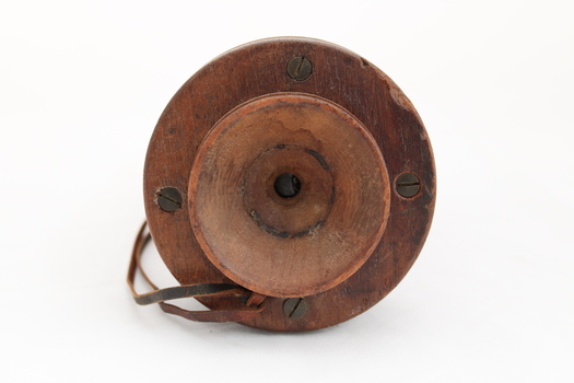Wooden rectangular device with cone shaped speaker/microphone at one end.