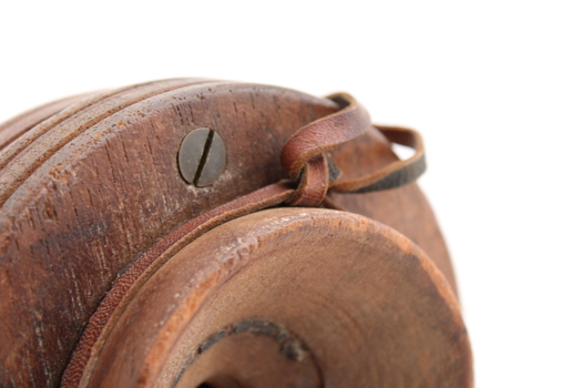 Wooden rectangular device with cone shaped speaker/microphone at one end.