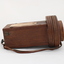 Wooden rectangular device with cone shaped speaker/microphone at one end.