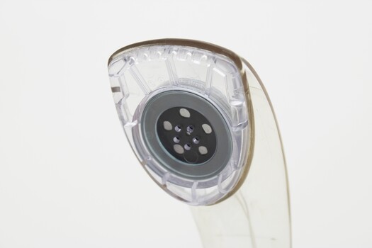 Clear plastic telephone with dial underneath long stemmed handle; colourful electrical wires visible within.