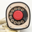Clear plastic telephone with dial underneath long stemmed handle; colourful electrical wires visible within.